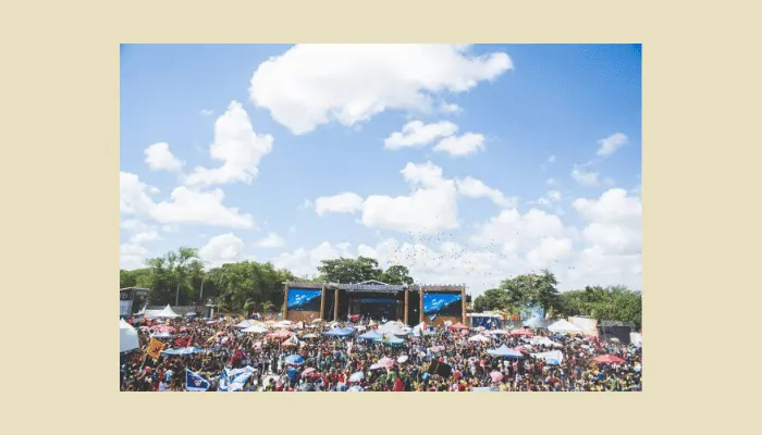 Outdoor summer festival stage under bright sunlight—an environment where temperature-sensitive germanium fuzz pedals may struggle.